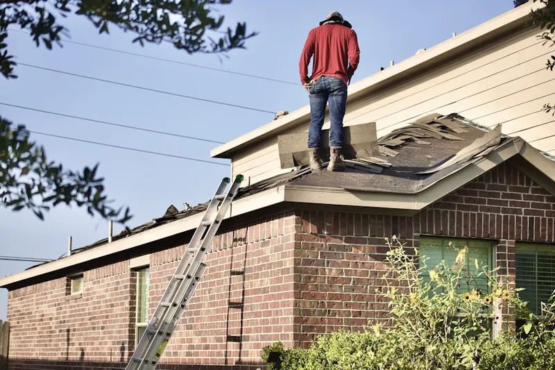 Professional roofer working on a residential roof in North Springfield